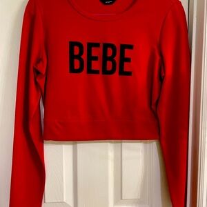 Women’s BeBe Red long sleeve crop top.